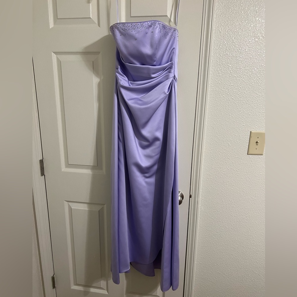Corset back, floor length prom dress with bead accent.